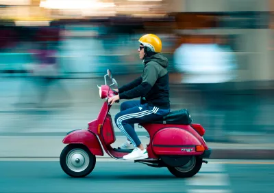 A scooter speeding through the street